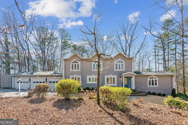 213 Pine Crest Dr, Cumming, GA 30040 - view of front of house with an attached garage, driveway, and stucco siding
