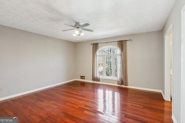 unfurnished room featuring a textured ceiling, dark hardwood / wood-style floors, and ceiling fan