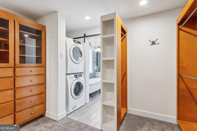 213 Pine Crest Dr, Cumming, GA 30040 - laundry area with stacked washer and clothes dryer, a barn door, and recessed lighting