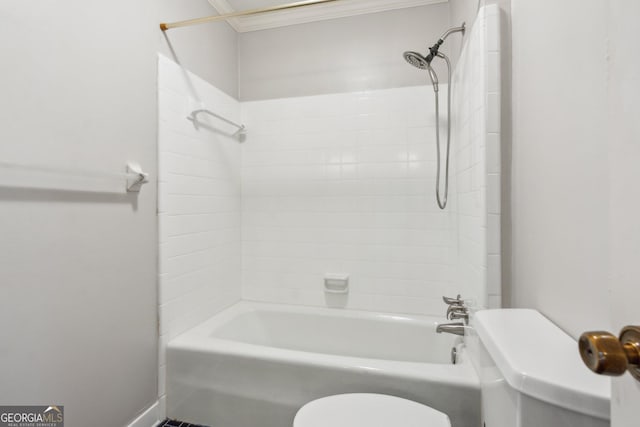 bathroom featuring tiled shower / bath combo and toilet