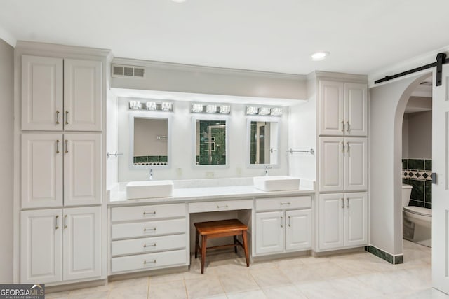 bathroom with vanity, tile patterned floors, ornamental molding, and toilet