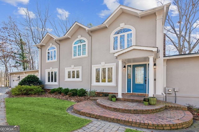 view of front of property with a garage and a front yard