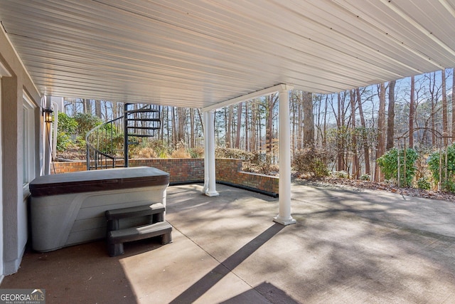 view of patio / terrace with a hot tub