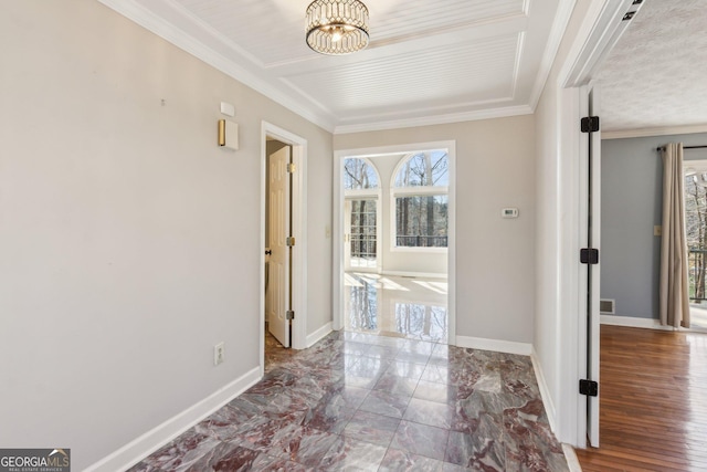 corridor with crown molding and a notable chandelier