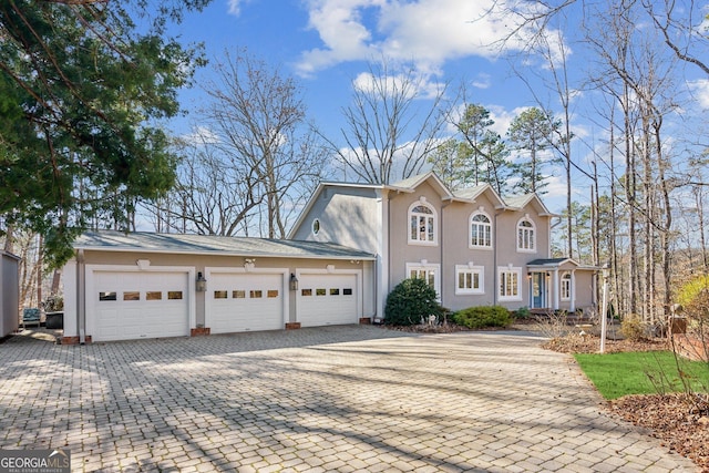 213 Pine Crest Dr, Cumming, GA 30040 - view of front of house with driveway, stucco siding, and an attached garage