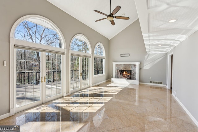 living room with high vaulted ceiling, a premium fireplace, and ceiling fan