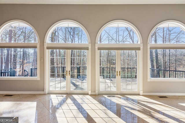 doorway featuring french doors and a high ceiling