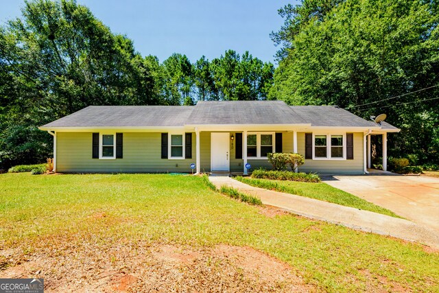 single story home featuring a front yard and solar panels