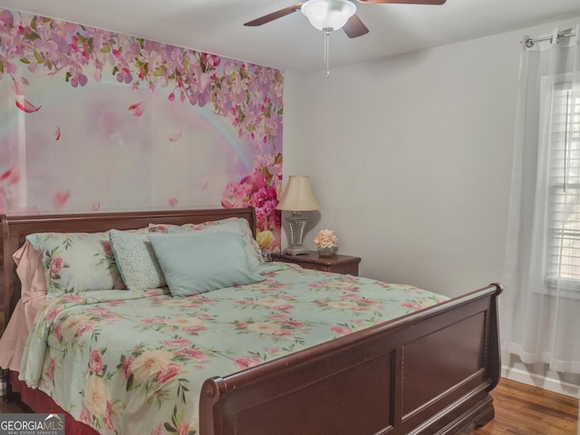 bedroom with a ceiling fan and wood finished floors