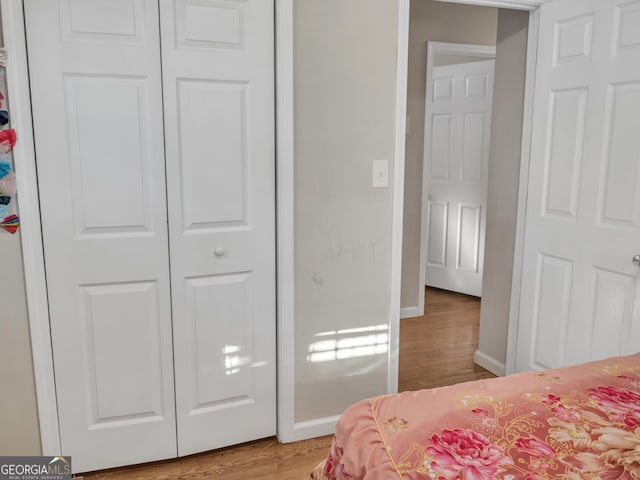 bedroom with light wood-style flooring and baseboards