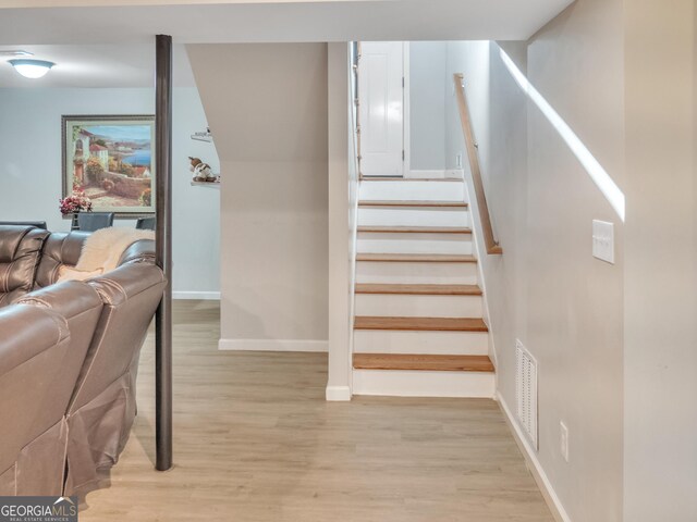 exercise room featuring light hardwood / wood-style floors