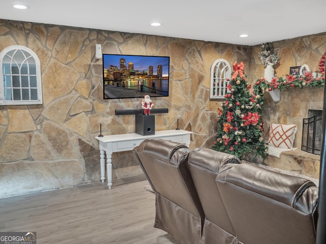 living room with a fireplace, wood finished floors, and recessed lighting