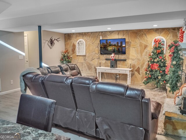 home theater room featuring baseboards, wood finished floors, and recessed lighting