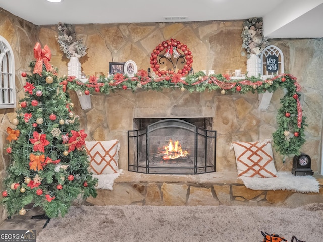 room details with a fireplace and visible vents