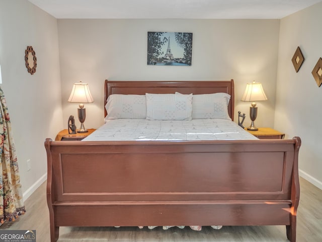 bedroom featuring light wood-type flooring and baseboards