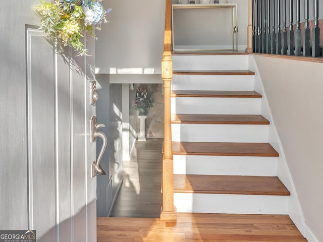 stairway with wood finished floors