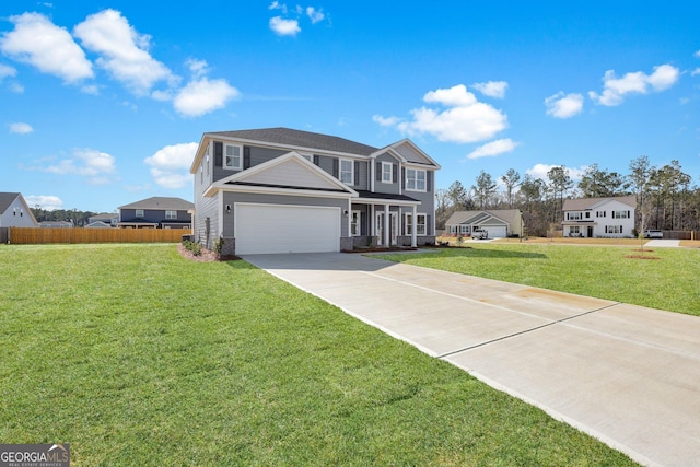 traditional home with a garage, concrete driveway, a front yard, and fence