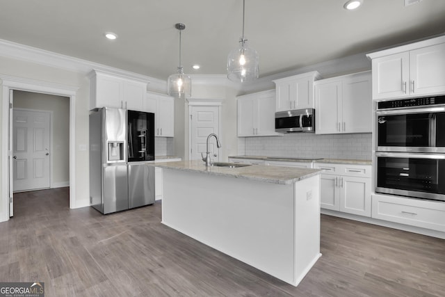 kitchen with a sink, stainless steel appliances, crown molding, and white cabinetry