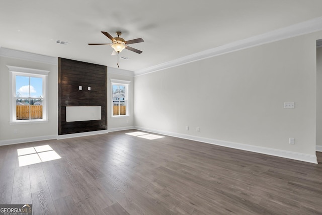 unfurnished living room featuring visible vents, a large fireplace, plenty of natural light, and ornamental molding