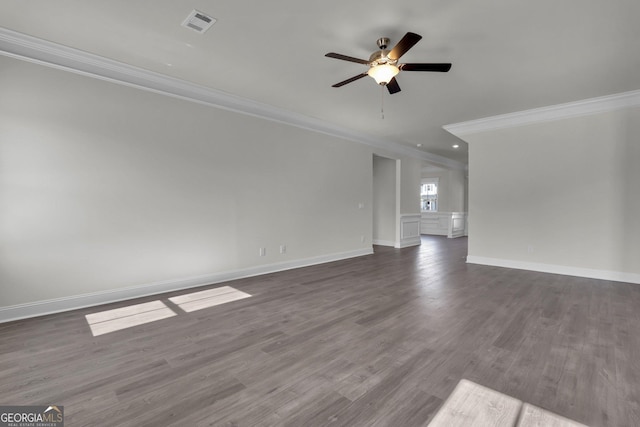 unfurnished living room with visible vents, baseboards, crown molding, and dark wood-type flooring