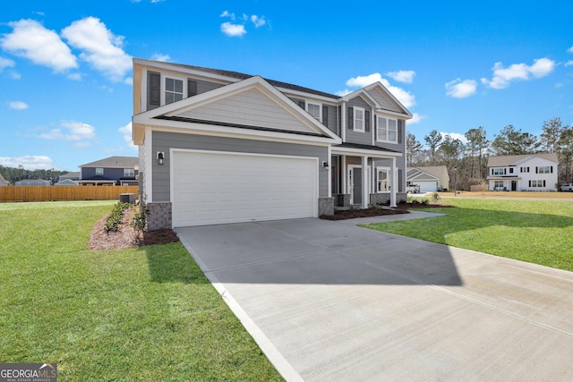 view of front of home featuring a front lawn, fence, a garage, and driveway