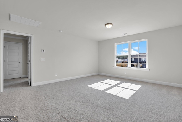 unfurnished room with carpet flooring, baseboards, and visible vents