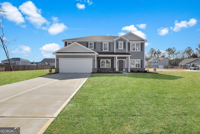 view of front facade featuring a garage, a front lawn, driveway, and fence