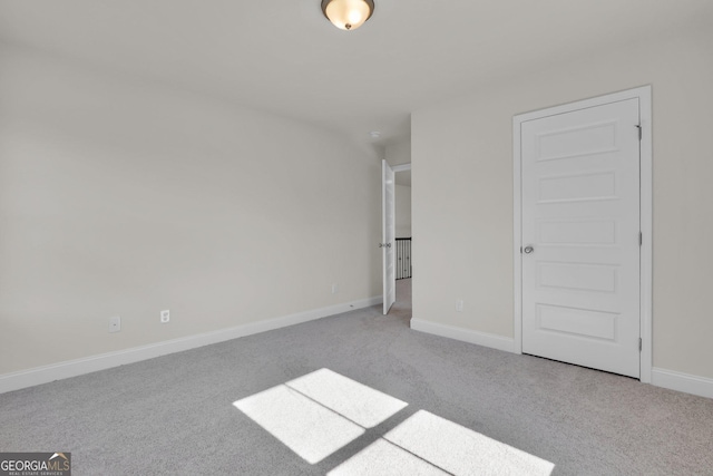 unfurnished bedroom featuring baseboards and carpet floors