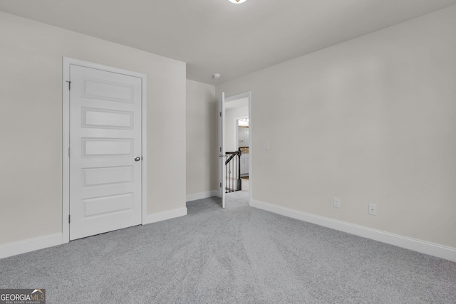 unfurnished bedroom featuring baseboards and carpet floors