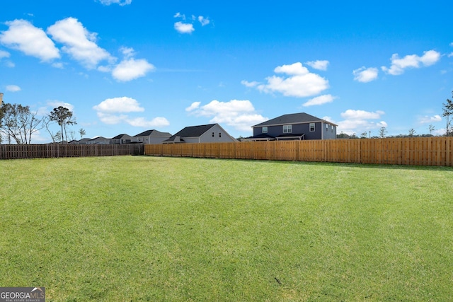 view of yard with a fenced backyard