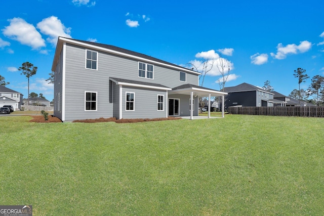 back of house featuring a yard, a patio area, and fence