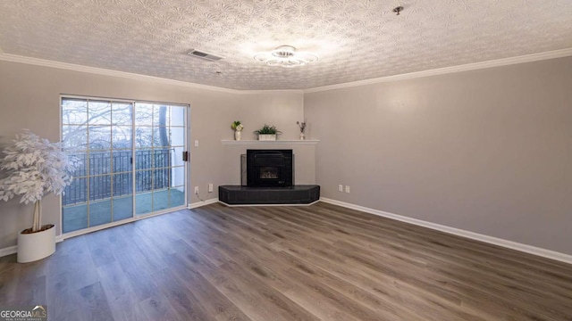 unfurnished living room featuring crown molding, dark wood-type flooring, and a textured ceiling