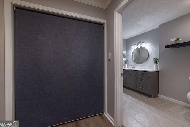 bathroom featuring vanity, a textured ceiling, and toilet