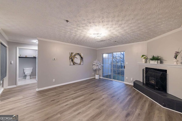 unfurnished living room with hardwood / wood-style flooring, crown molding, and a textured ceiling