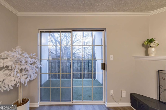 doorway with crown molding, hardwood / wood-style flooring, and a textured ceiling