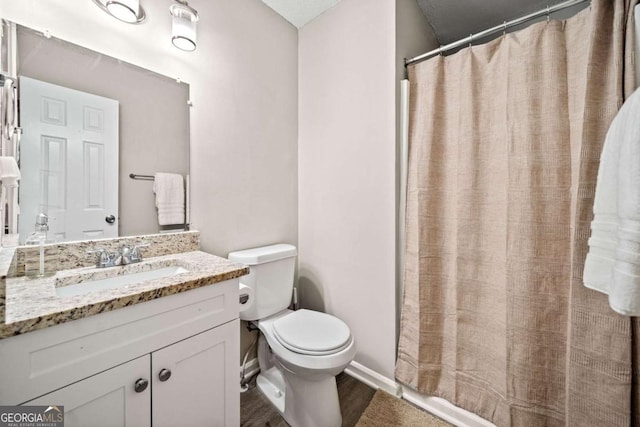 bathroom with hardwood / wood-style flooring, vanity, toilet, and a shower with shower curtain