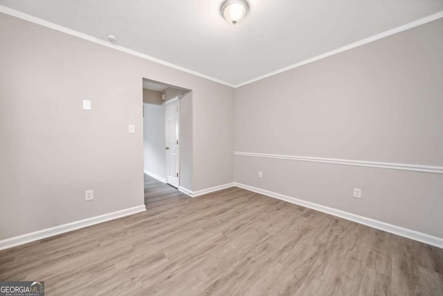 unfurnished room with wood-type flooring and crown molding