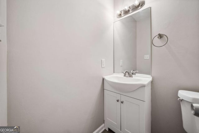 bathroom featuring vanity and toilet