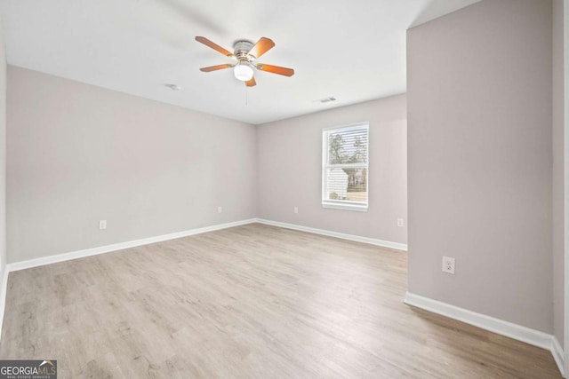 empty room with ceiling fan and light wood-type flooring