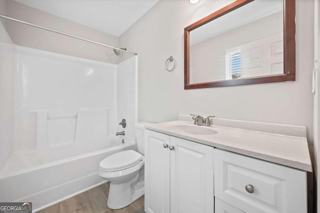 full bathroom with vanity, wood-type flooring,  shower combination, and toilet