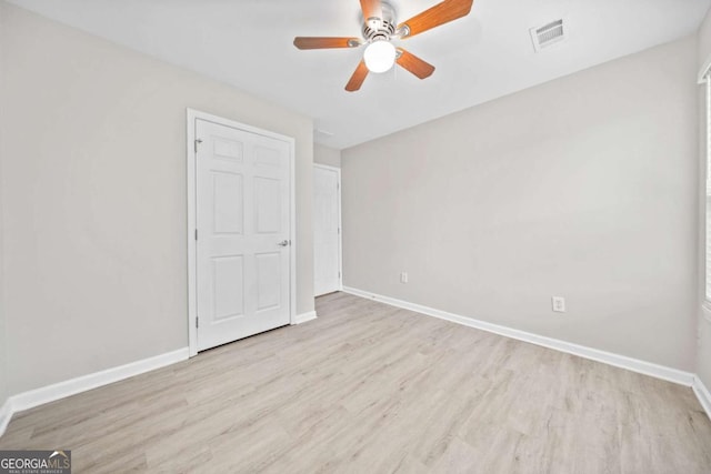 spare room featuring ceiling fan and light hardwood / wood-style floors