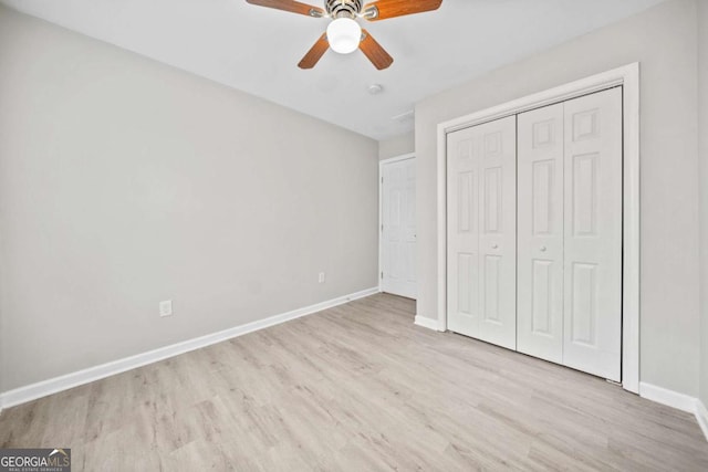 unfurnished bedroom with ceiling fan, light hardwood / wood-style floors, and a closet