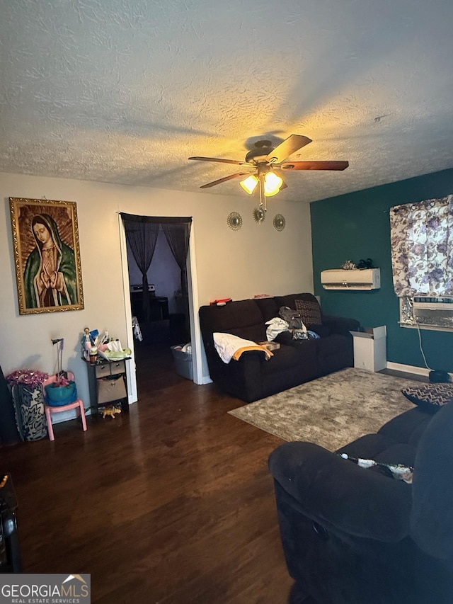 living room featuring ceiling fan, dark hardwood / wood-style floors, and a textured ceiling