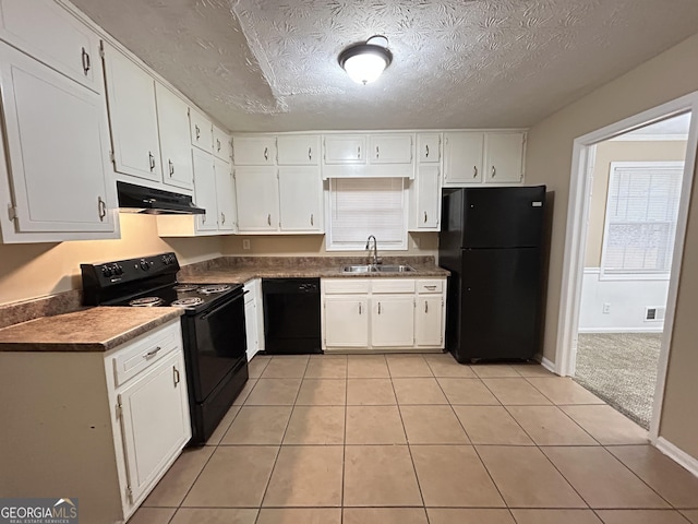 kitchen featuring white cabinets, light tile patterned floors, sink, and black appliances