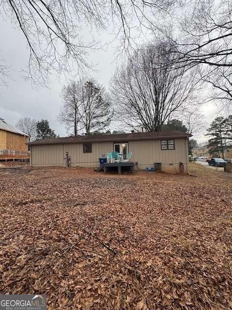 back of property featuring central AC