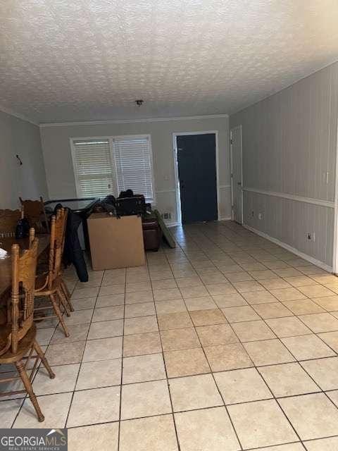 tiled dining area with a textured ceiling