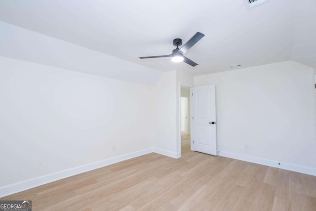 spare room with ceiling fan, lofted ceiling, and light hardwood / wood-style floors