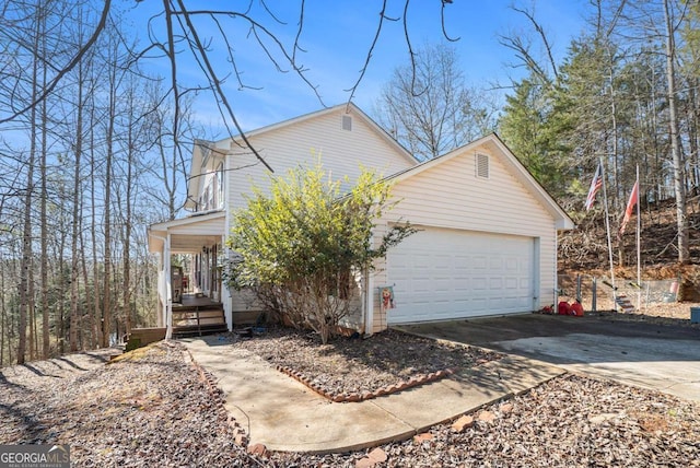 view of front of home with driveway, a porch, and an attached garage