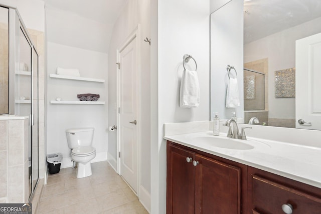 bathroom with vanity, walk in shower, tile patterned floors, and toilet