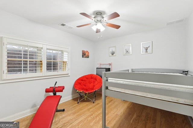 bedroom with ceiling fan and light wood-type flooring